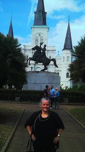 My mother poses in front of the statue of the Hero of New Orleans who fought the British Empire and become President and the Church of the Sainted Crusader King.