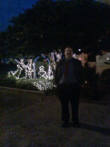 Me in front of a Christmas lights nativity scene shot by one of the proprietors on my phone as I walked into the Donors Dinner.